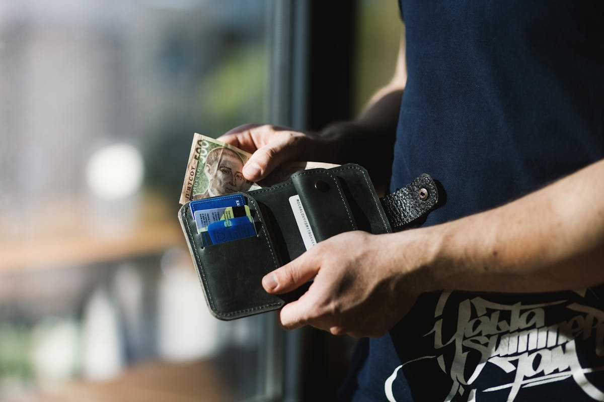 Leather wallet with cash representing home equity tapped through a cash-out refinance or HELOC